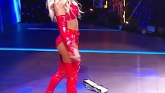 WWE – Carmella in red outfit standing over Sasha Banks